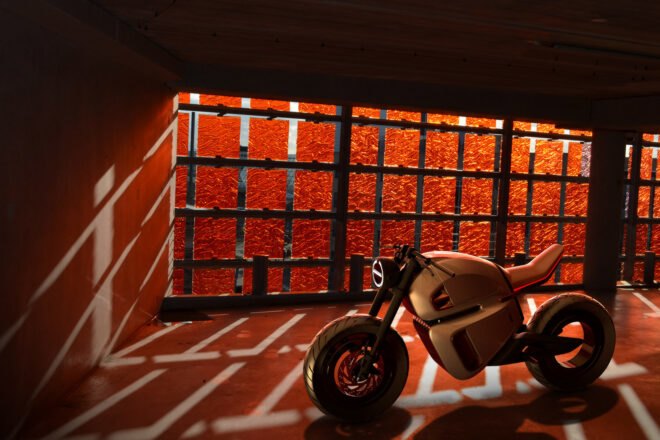 hybrid motorcycle parked in dark underground garage area