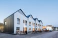 white and dark steel homes with sharply angled roofs