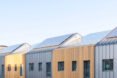 solar panels on top of wood and steel row homes