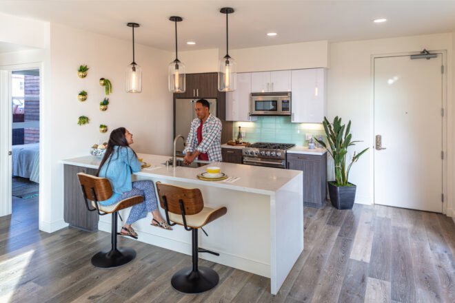 people talking across a white kitchen island