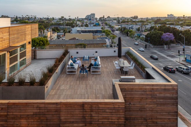 aerial view of friends sitting on sofas on outdoor deck