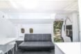 gray sofa in a tiny room with a curved ceiling