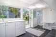 white living area with kitchenette and bathroom