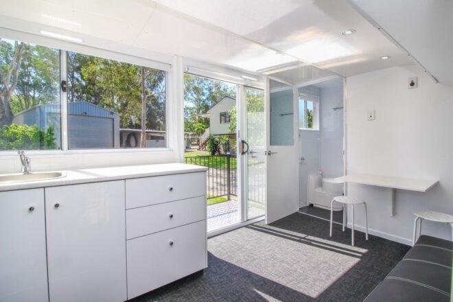 white living area with kitchenette and bathroom