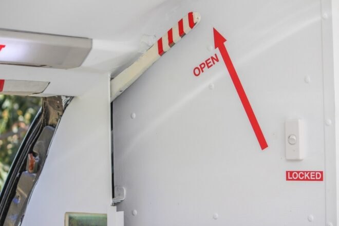 white wall with red arrow and word "Open"