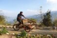 person riding a bamboo bike on remote path