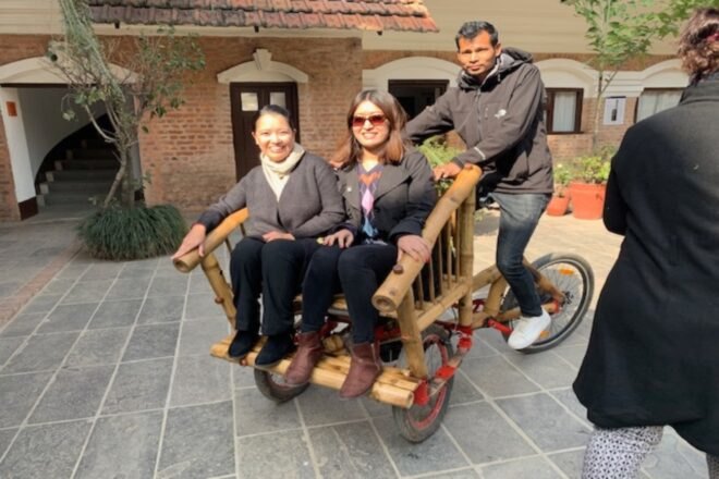 couple being transported by bamboo bike
