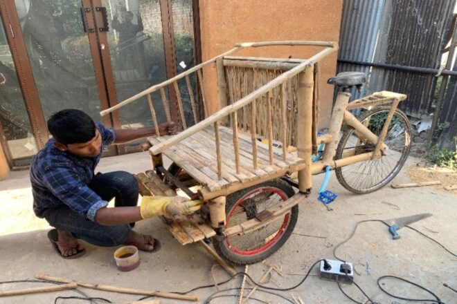 person building a bamboo bike