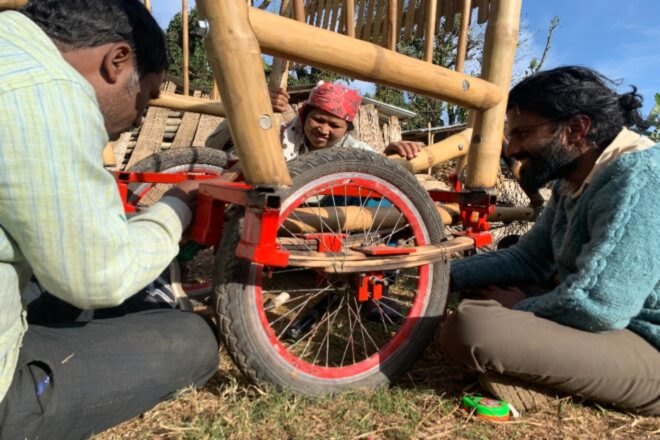 person doing maintenance work on bamboo bike's wheel
