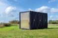 rectangular black cabin with glass entrance