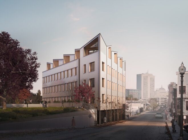 a view from the corner of a building rendering with paneled facade and windows. to the left is a raised green area with a tree. to the right is a city street.