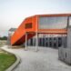 orange shipping containers with large glass windows