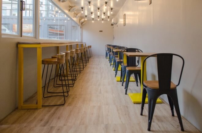 cafe with wood and yellow dining tables and chairs