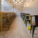 cafe with wood and yellow dining tables and chairs