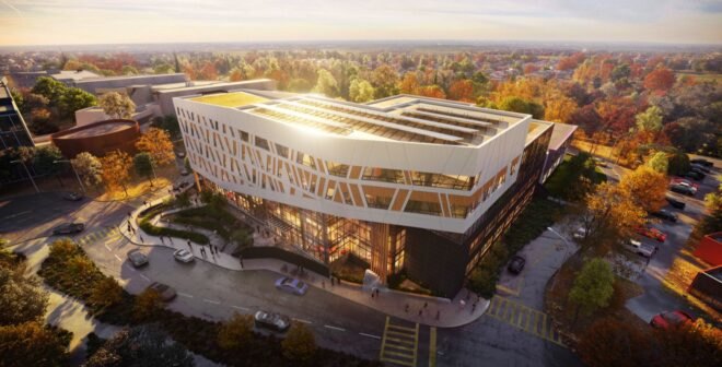 solar panels reflecting sunlight atop a large white college building