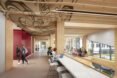 white desks under a patterned wood ceiling