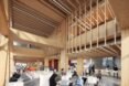 large rooms with big windows and wood-beamed ceilings