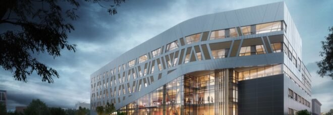 large white building with patterned facade at dusk