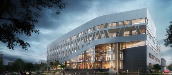 large white building with patterned facade at dusk
