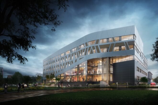 large white building with patterned facade at dusk