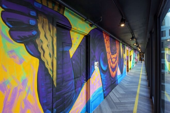 outdoor mural with purple and yellow colors