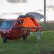 Little red vehicle with tent folded out to the side