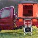 Side view of camper with orange tent