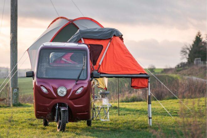 Little red vehicle with an orange camper on top
