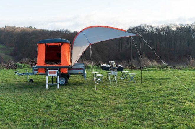 gray tarp extended out over table