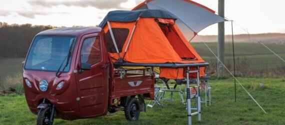 red camper with orange tent