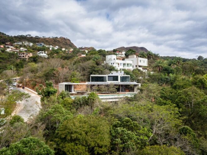 large home on a hill surrounded by greenery
