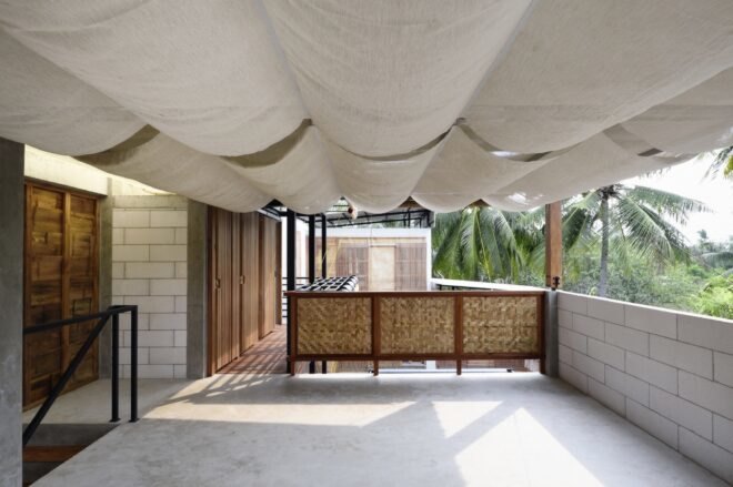 a covered, open air area with white floors and a wood hallway