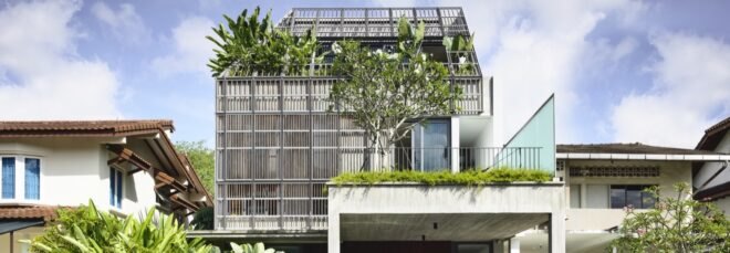 tall white home with timber slats on second floor