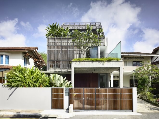 tall white home with timber slats on second floor