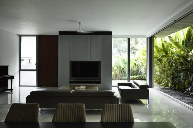 dark dining table behind a gray sofa