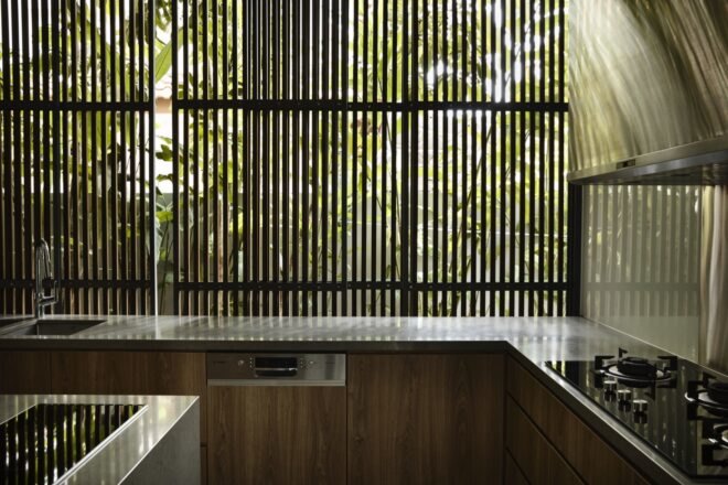 kitchen with wood cabinets and windows covered by timber slats