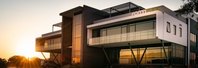a building with a black structure in the middle and white structures on wither side
