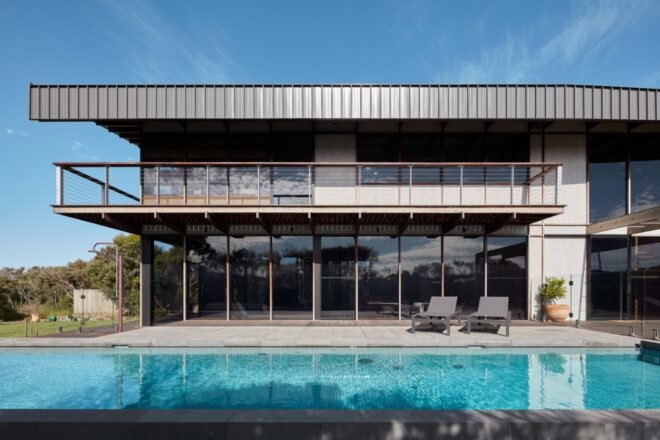 pool in front of two-story home