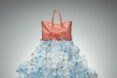red tote bag on pile of plastic water bottles