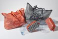 red tote bag and black tote bag near empty plastic bottles