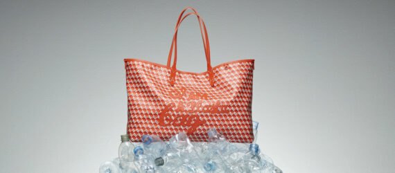 red tote bag on pile of plastic water bottles