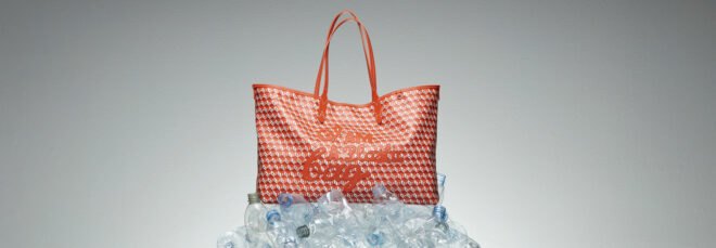 red tote bag on pile of plastic water bottles
