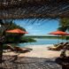 outdoor pool with lounge chairs and red umbrellas