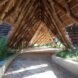 a winding walkway covered in thatched roof
