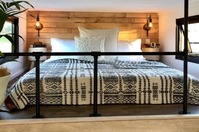 a large bed behind a metal railing