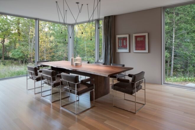 wood dining table near full-height windows