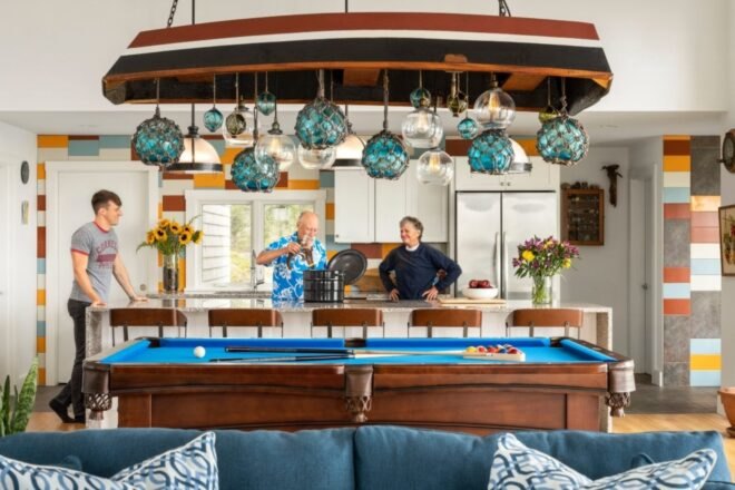 three people behind a blue billiards table