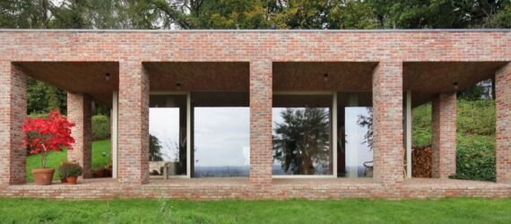 elongated brick home with front patio