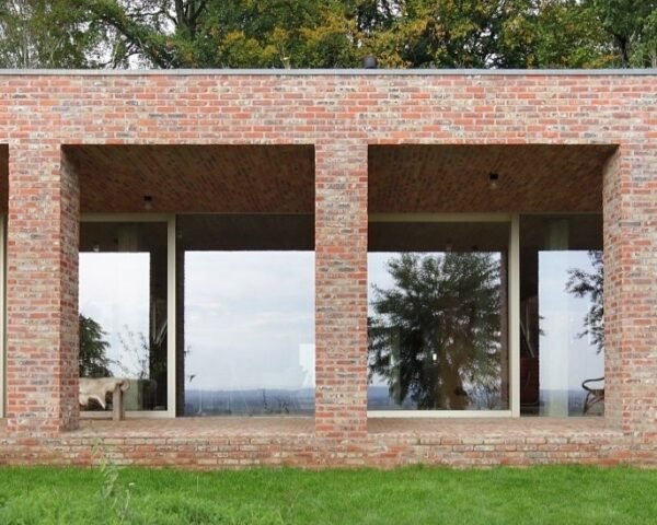 elongated brick home with front patio