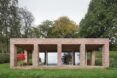 elongated brick home with front patio